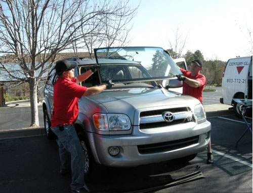 Windshield being replaced by 2 Century Glass Techs.